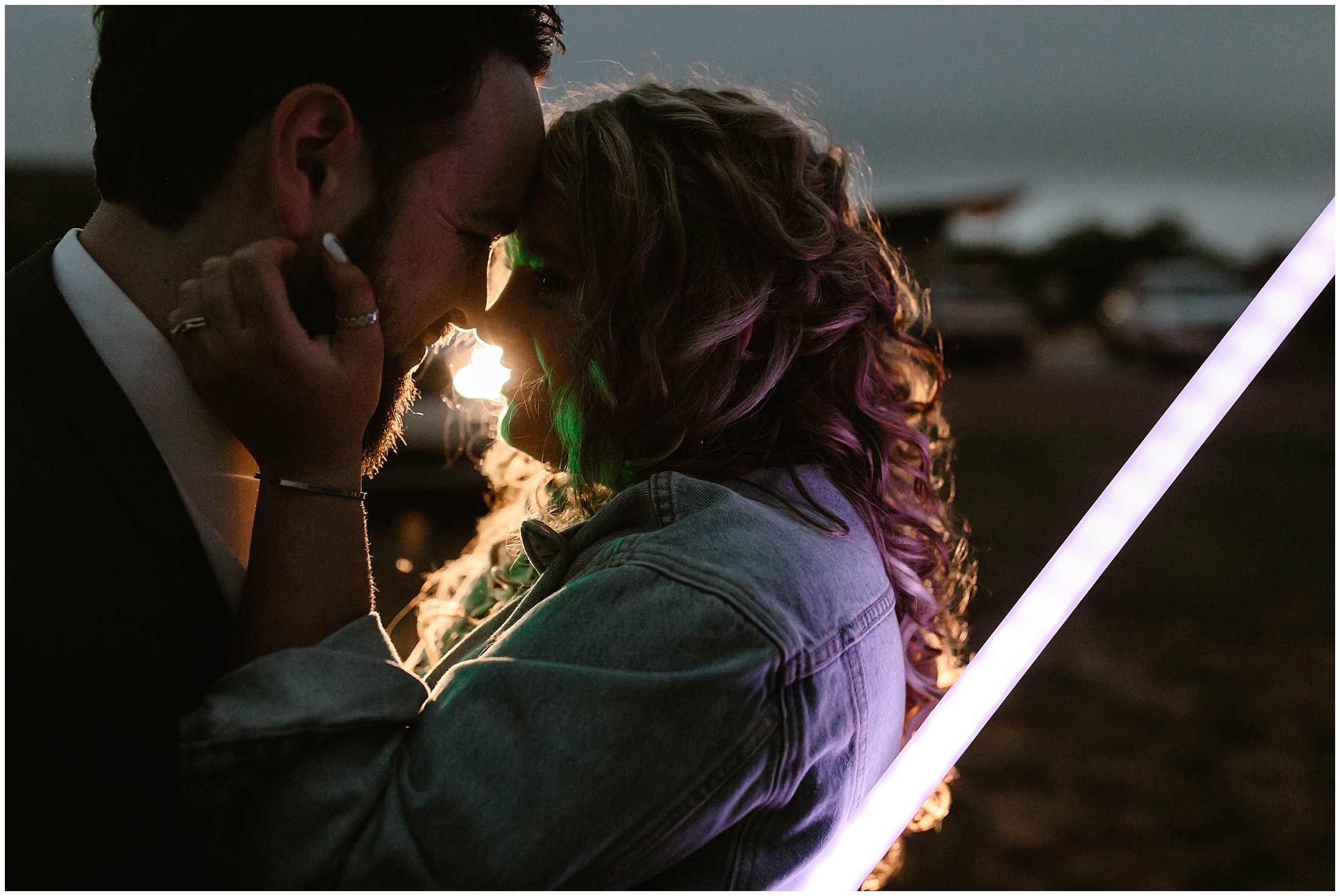 couple embracing with their light sabers on their may 4th wedding day in palo duro canyon