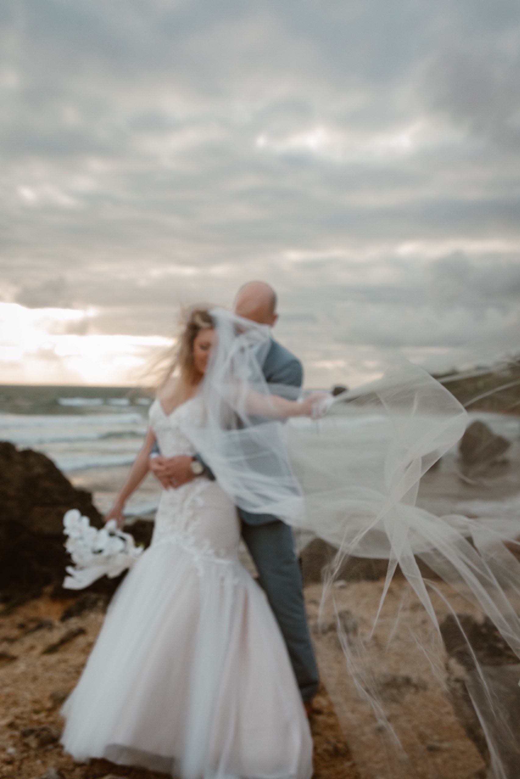 Bride and groom on a Barbados beach at golden hour